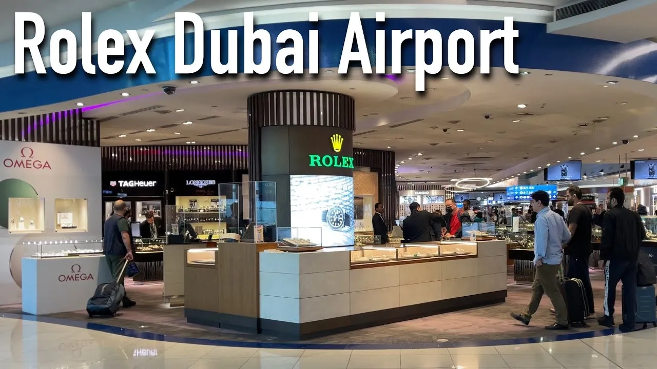Shoppers explore luxury watch boutiques including Rolex, Omega, Tudor, and others at Dubai Airport duty-free.